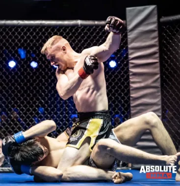 A fighter landing ground strikes on his opponent inside the cage