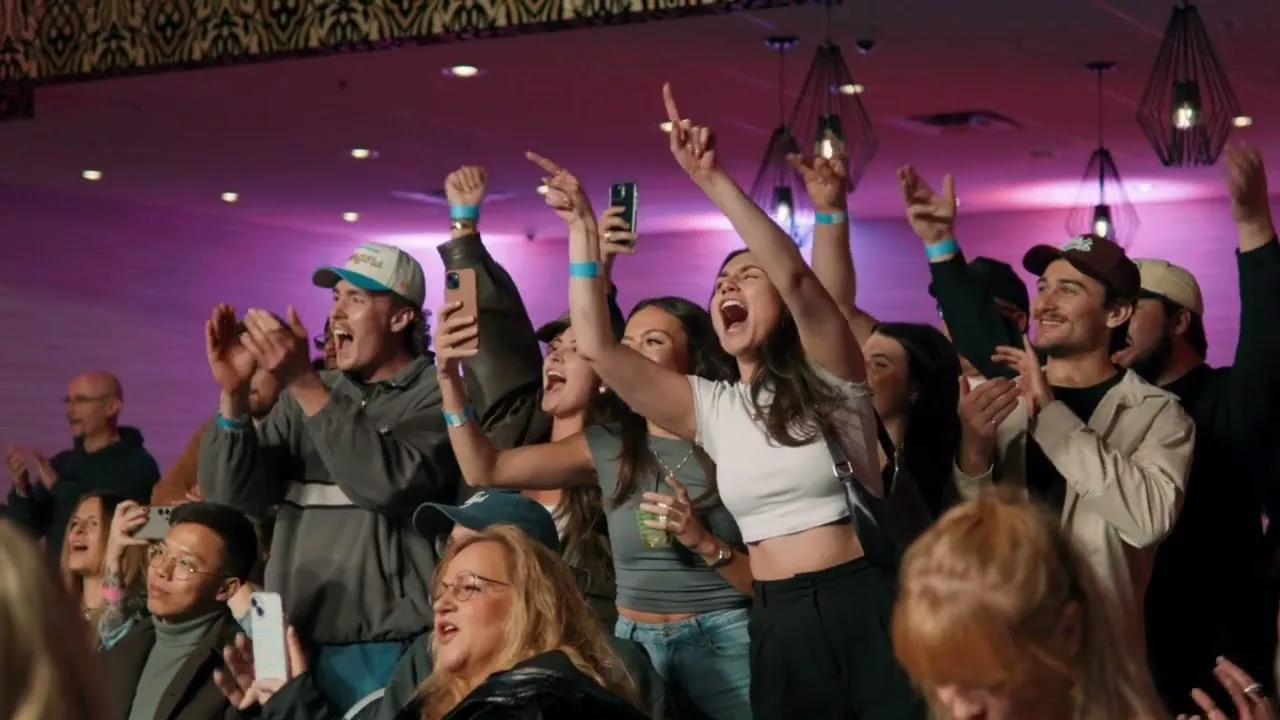 The crowd at an Absolute MMA night, on their feet with drinks in hand